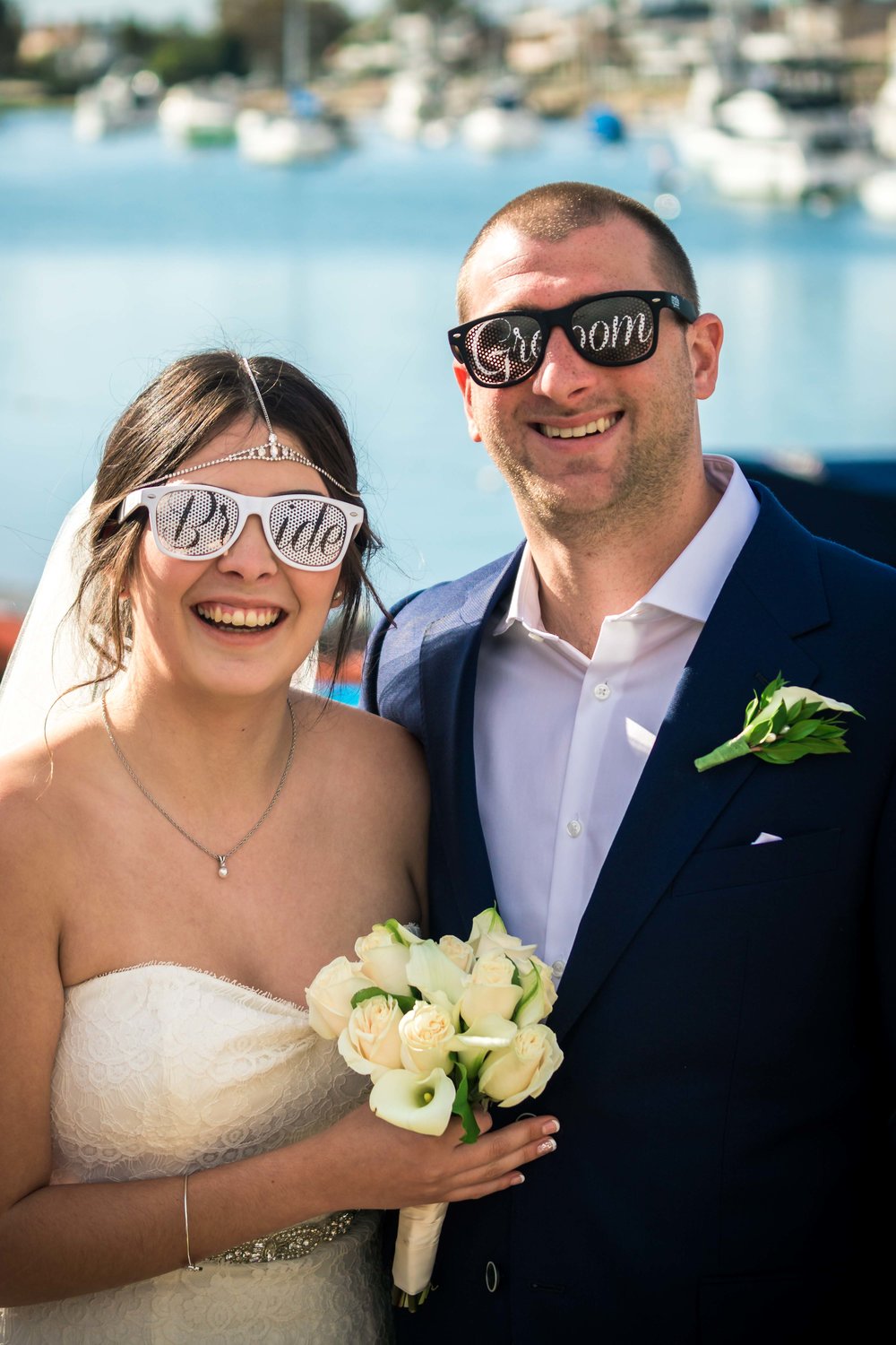 Bride and groom smiling and wearing their cool sunglasses