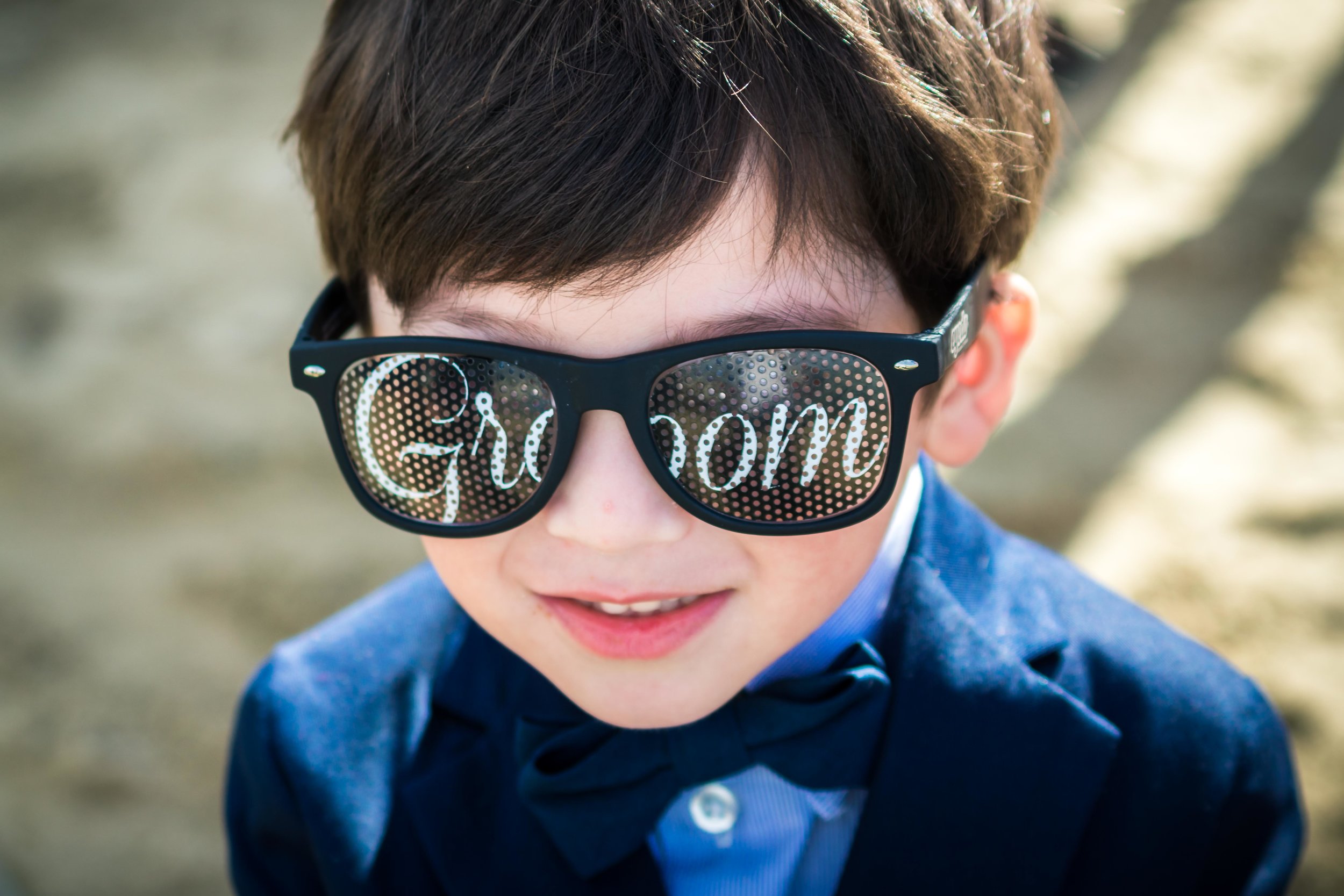 The ring bearer wearing sunglasses that Say groom
