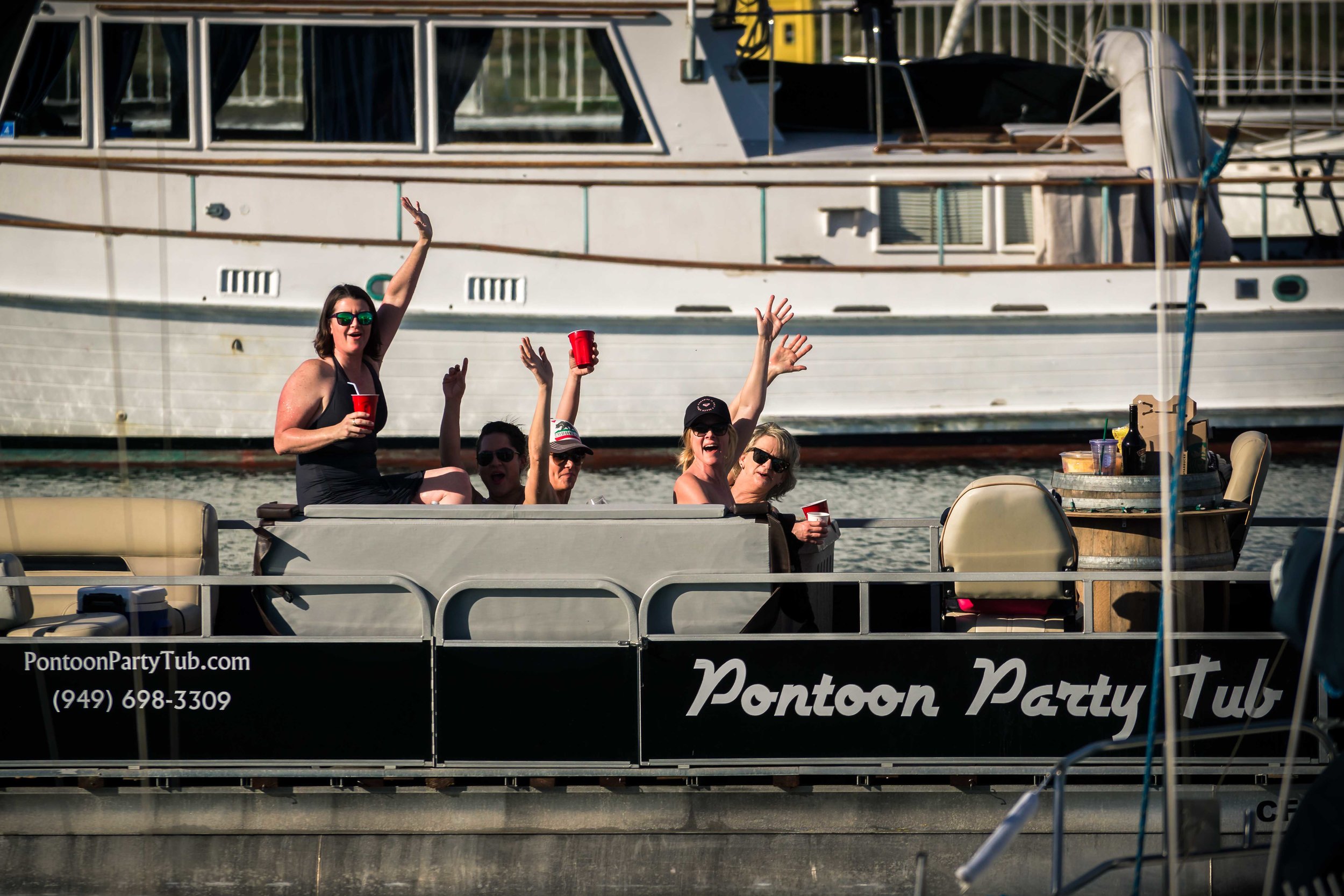 Passerbys on a boat waving and cheering on for the wedding