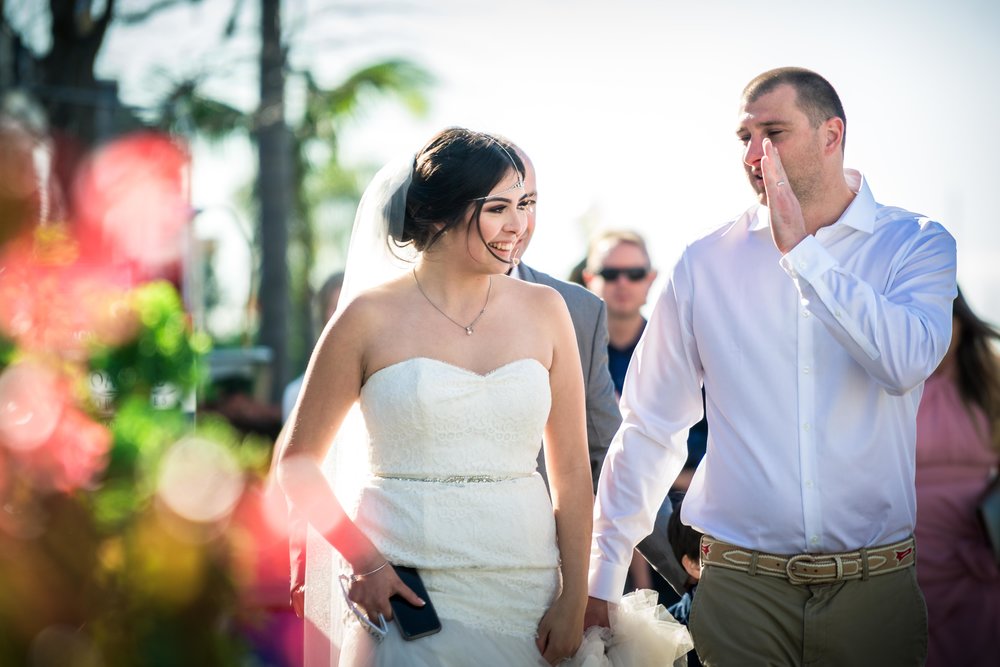 The bride and groom laughing together