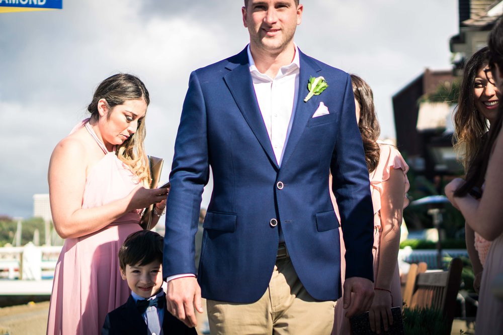 The groom and the ring bearer standing next to each other for portrait