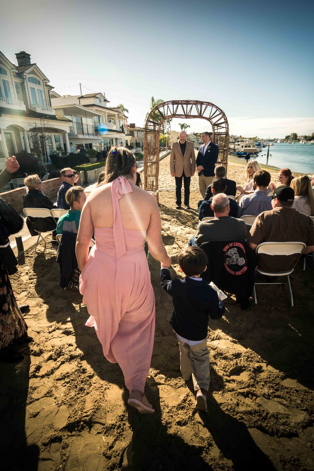 The ring bearer and the mother walking down the aisle