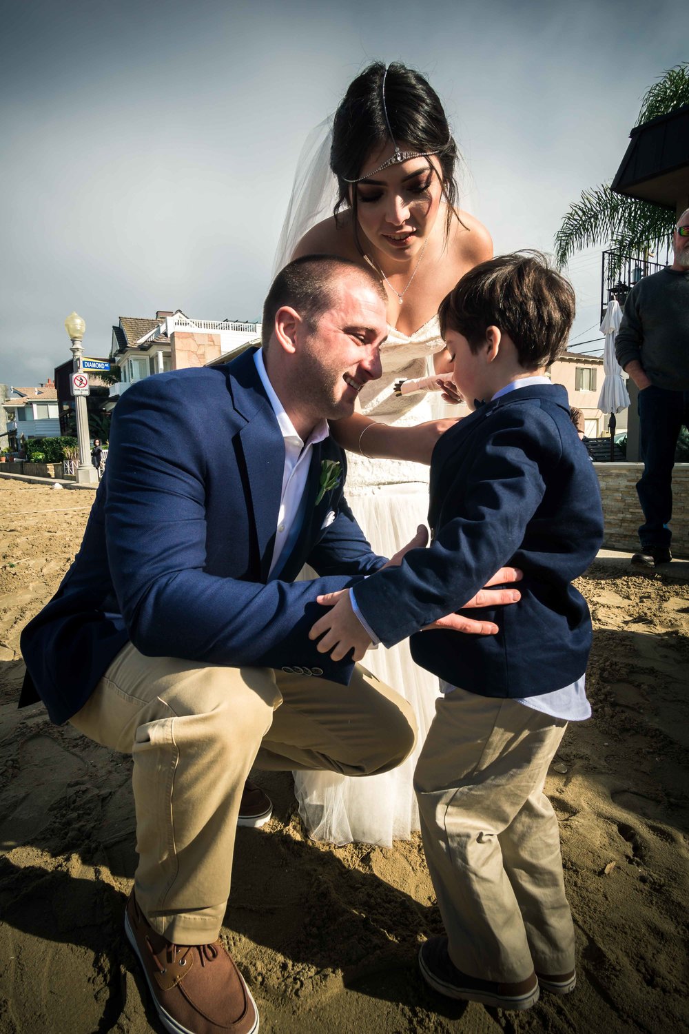 The bride and groom with the ringbearer after the reception