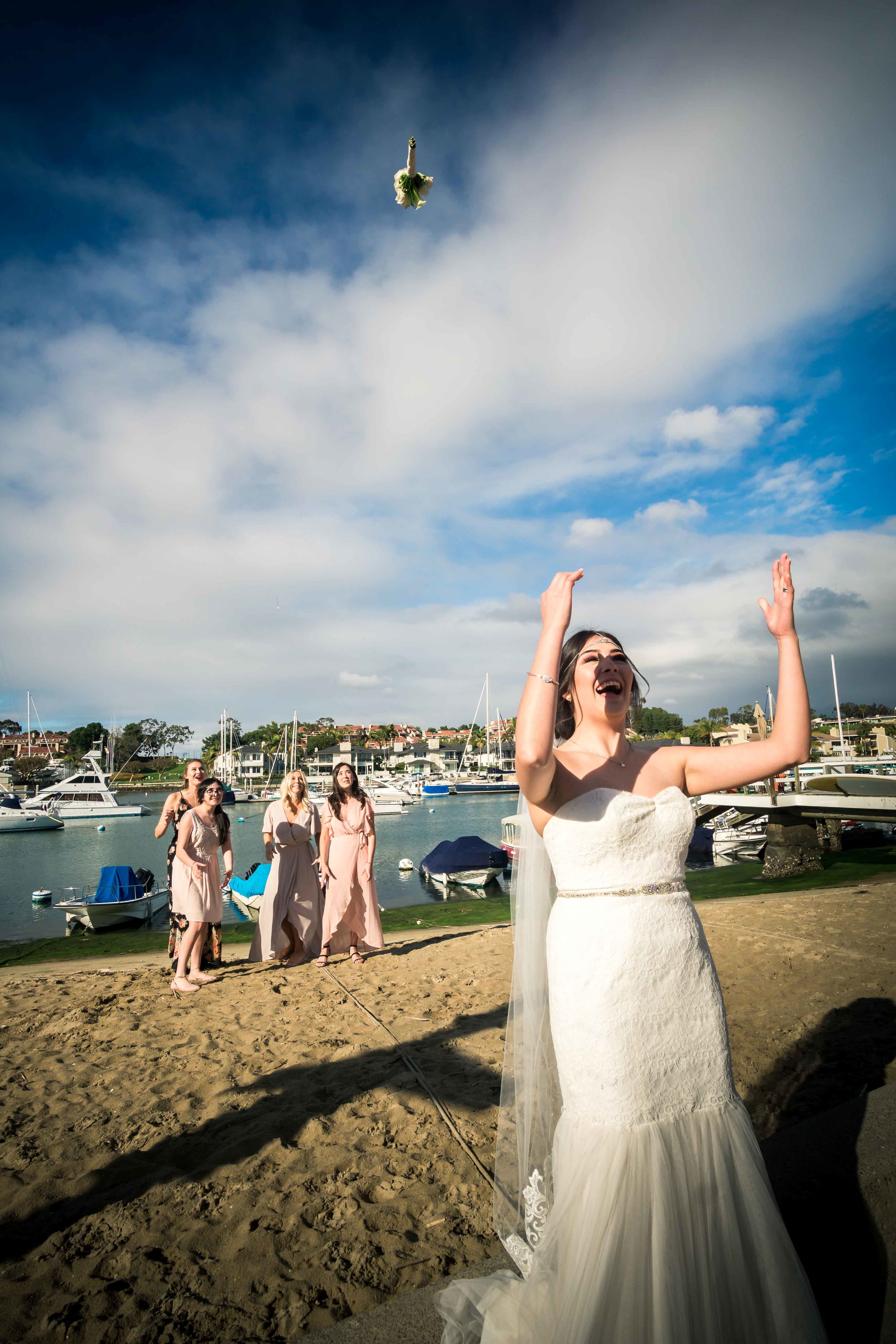 The bride tossing bouquet To the bridesmaids