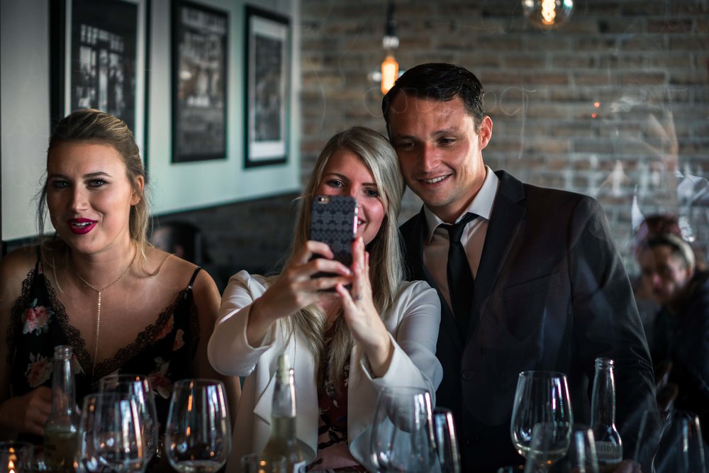 Wedding guest smiling and taking selfies at the Royal hen restaurant