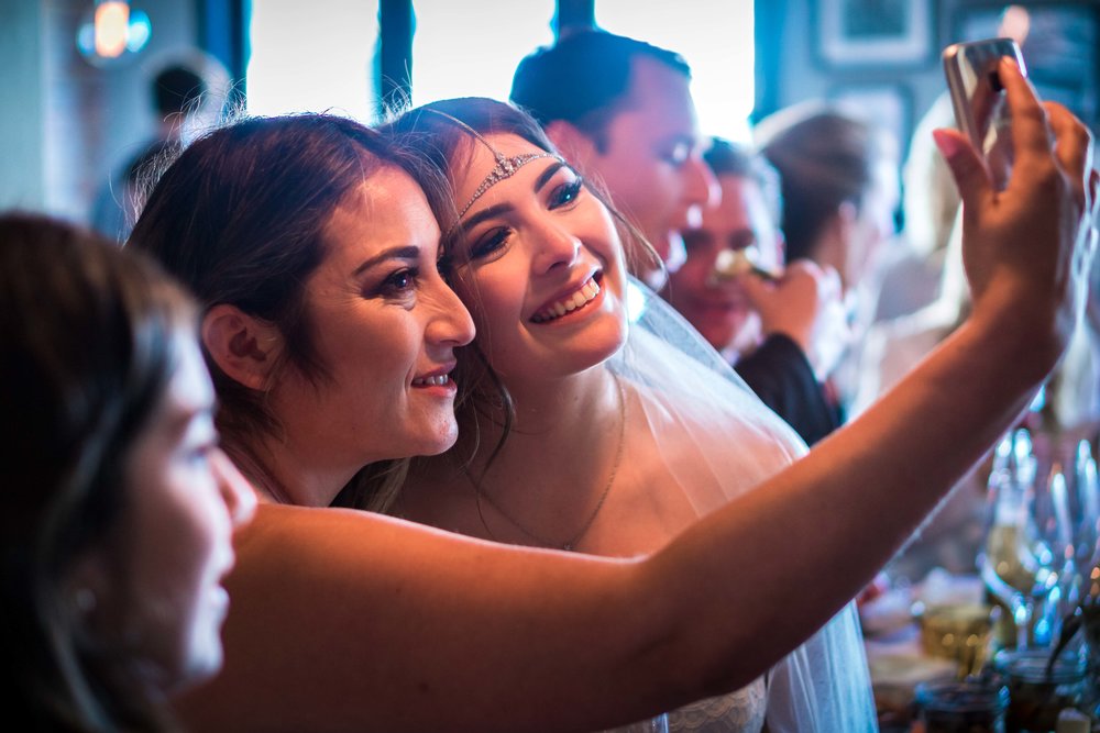 Bride and her mom taking a selfie at the wedding reception at the Royal hen restaurant