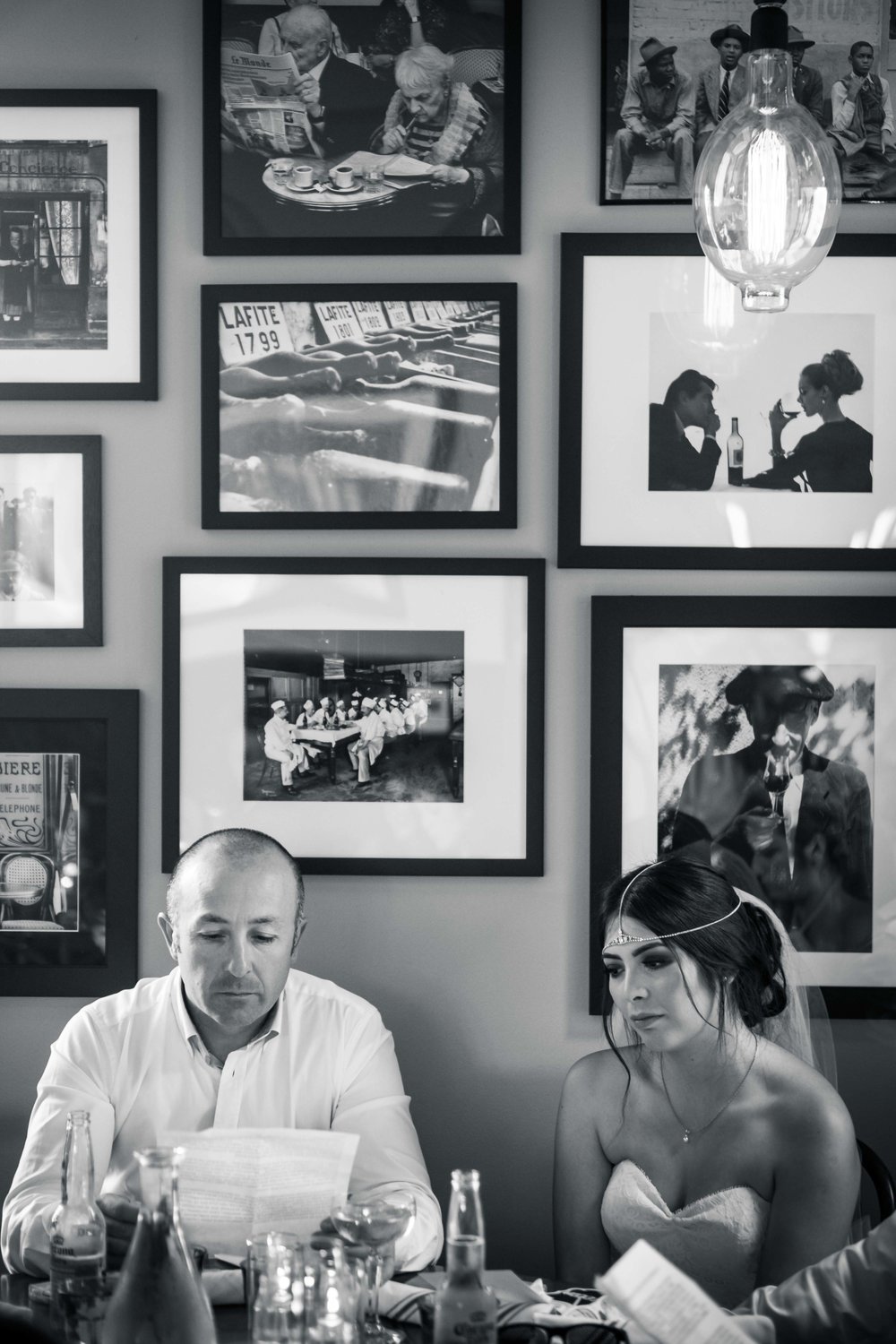 Black and white candid photo of the bride and father at the wedding reception