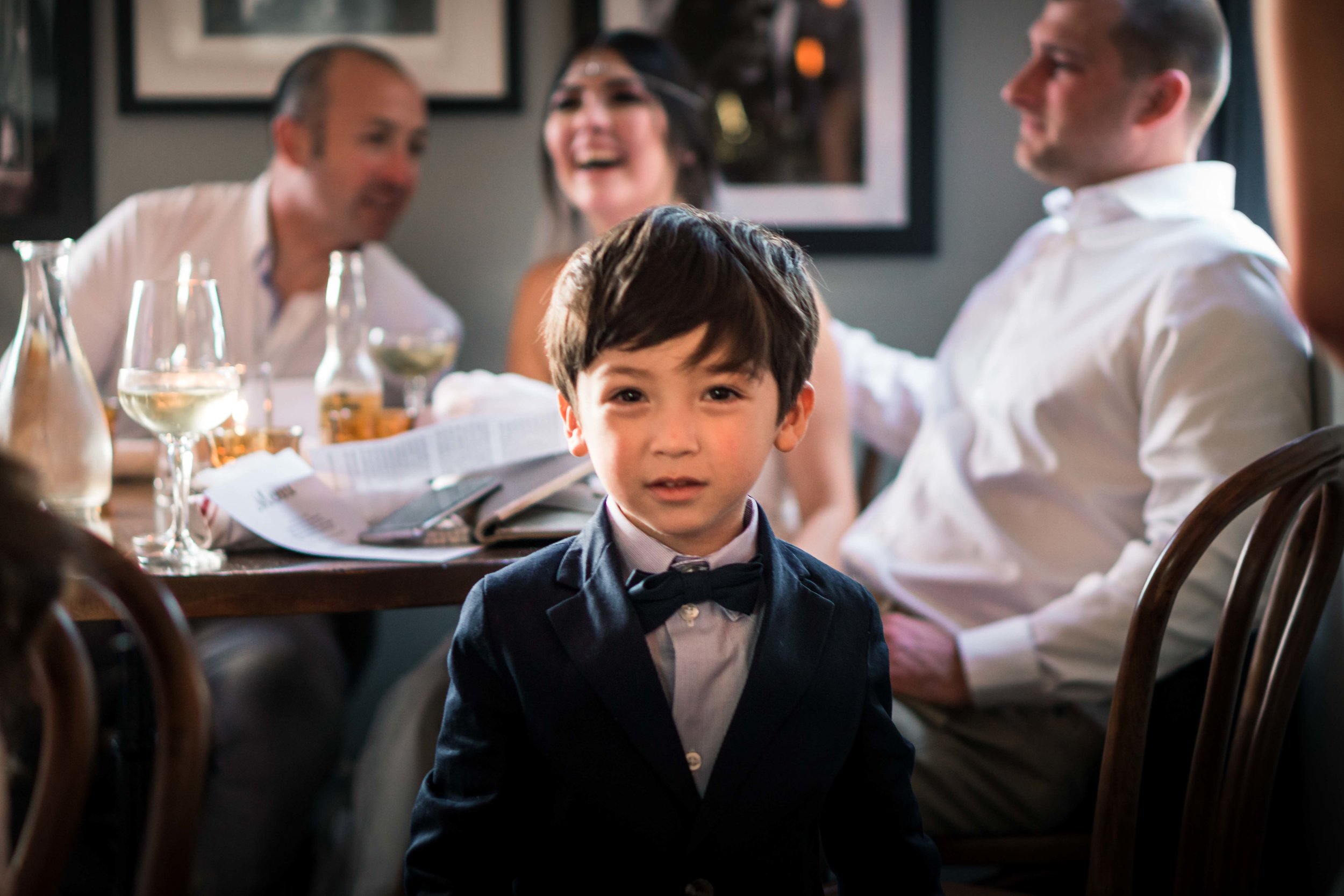 Cute photo of the ring bearer boy looking  At the camera