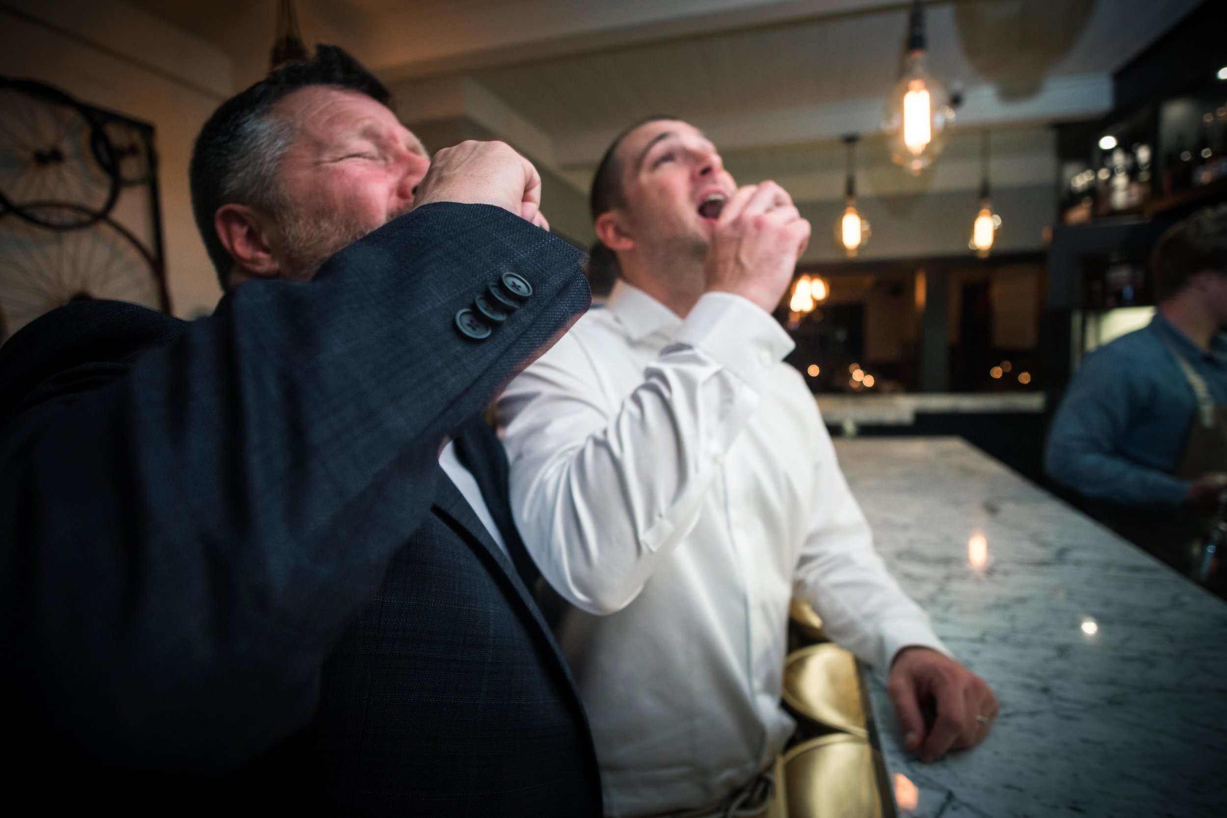 Broom and groom's father's expression taking tequila shots At the royal hen restaurant On Balboa Island