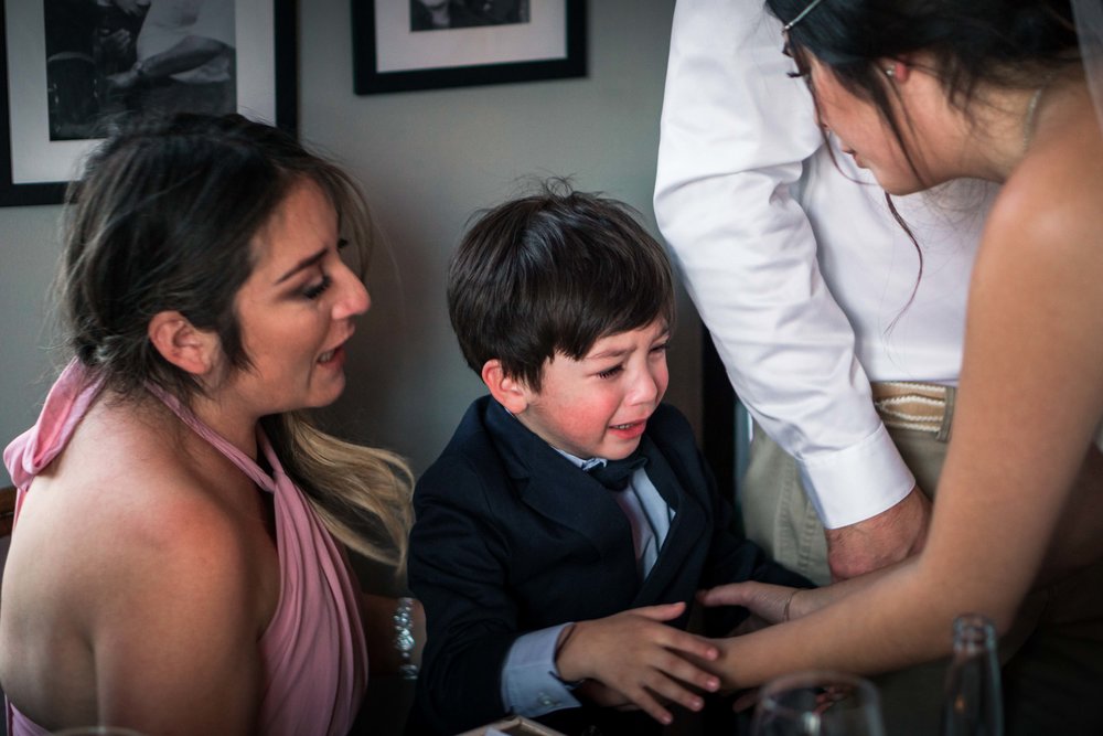 The ring bearer crying at the wedding reception