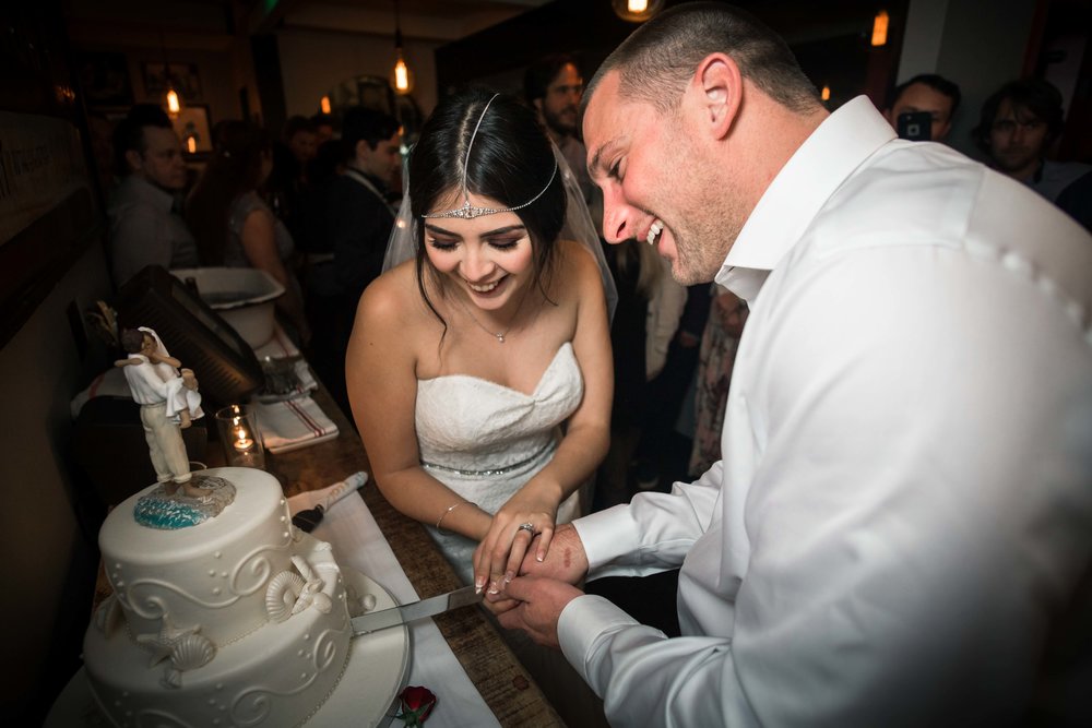 The wedding couple cutting the cake