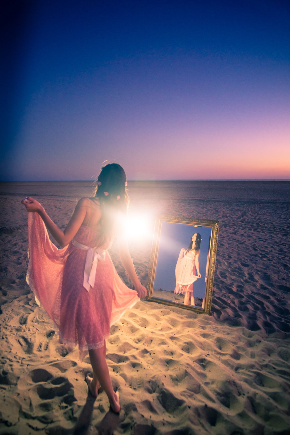 Portrait of a Lady in mirror wearing a pink dress at sunset  on Balboa Island in Newport Beach California By Joseph Barber photography