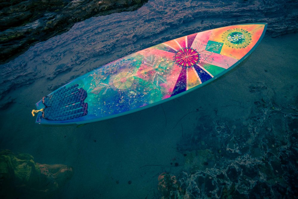 photo of custom hand painted surfboard at little corona beach tidepools 