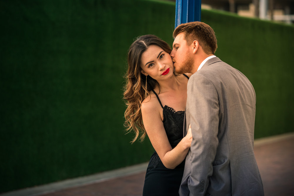 Photo of a couple kissing in downtown Long Beach during a couples photo shoot