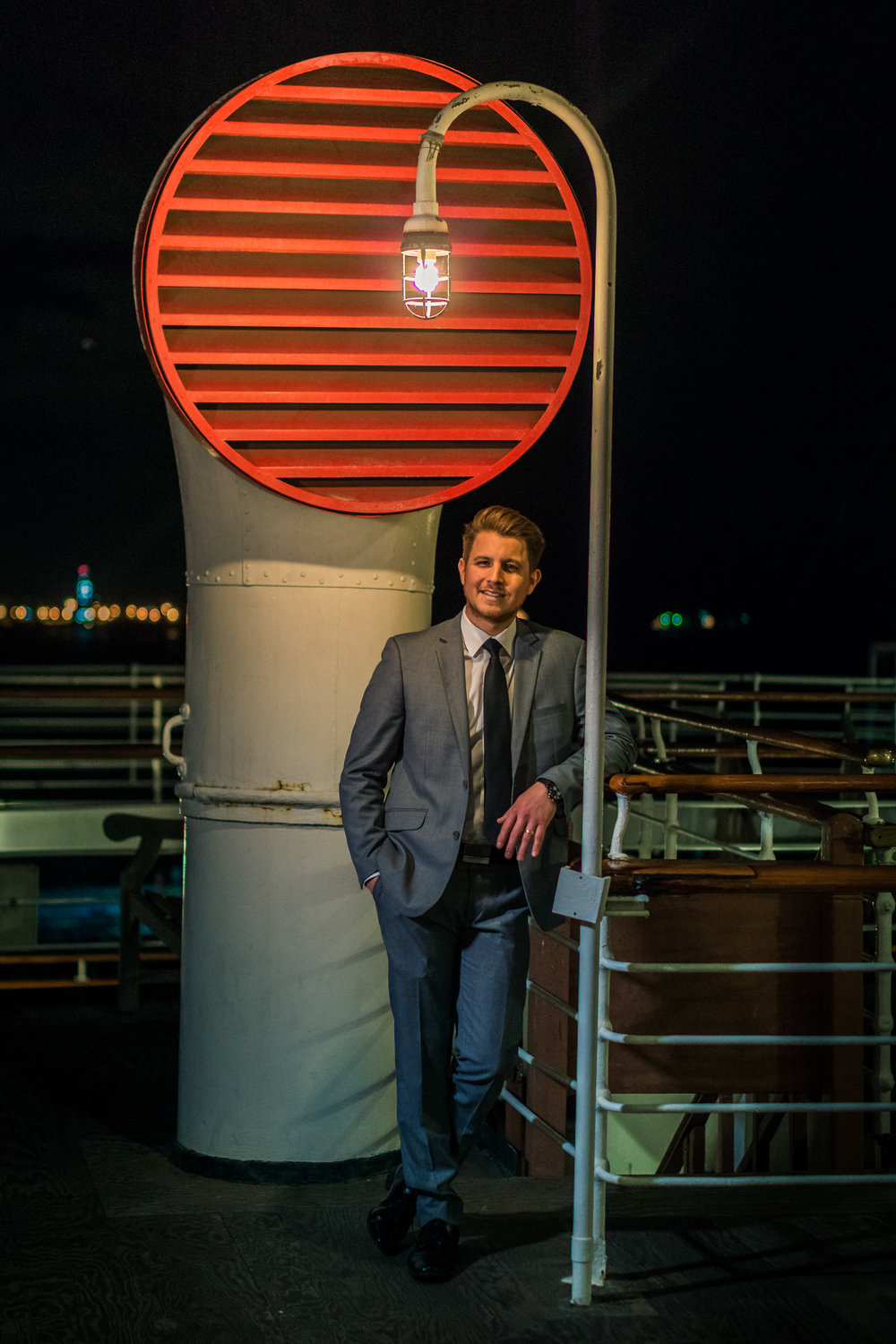 Photo of the groom in a gray suit TakePhoto shoot on the Queen Mary during a couples photoshoto