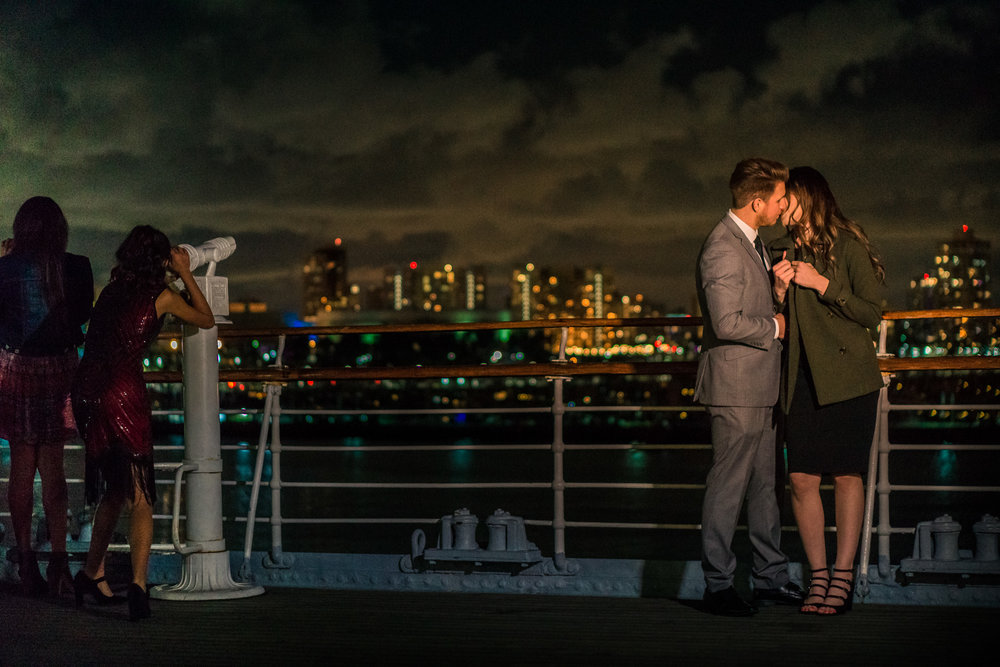 Photo of a couple kissing on the deck of the Queen Mary During an engagement shoot in Long Beach California