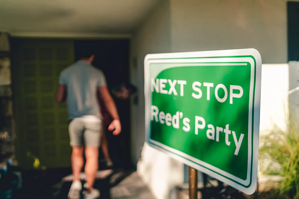 Newport Beach Rad Hot Wheels Party | guy walking by sign