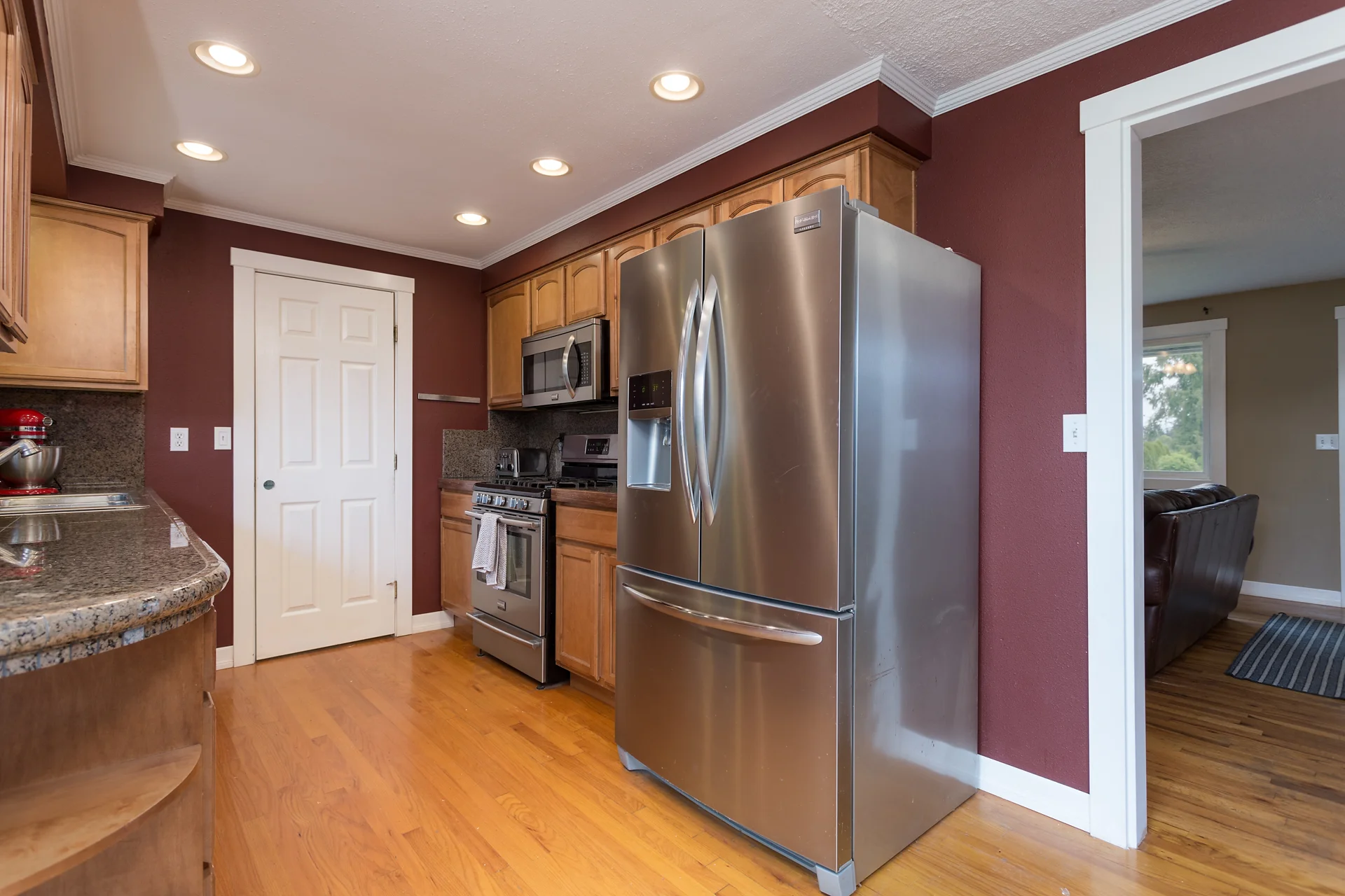 Remodeled kitchen with granite counters and stainless steel appliances.