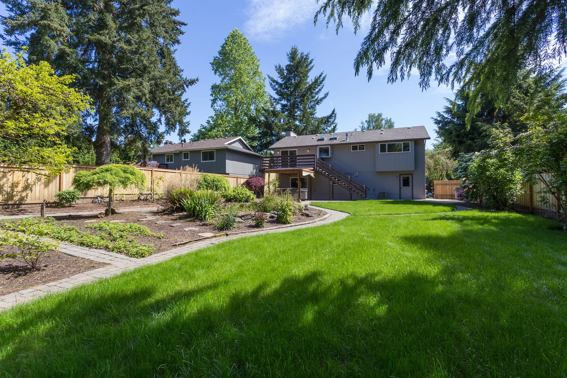 Park-like backyard with walking little walking paths among the gardens.