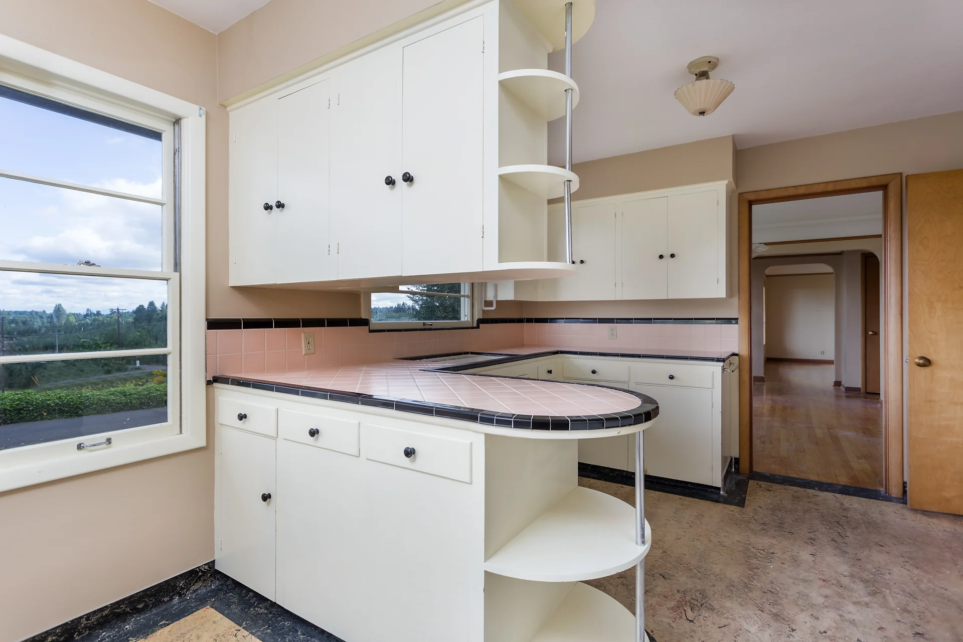 Kitchen with breakfast nook and vintage counters.
