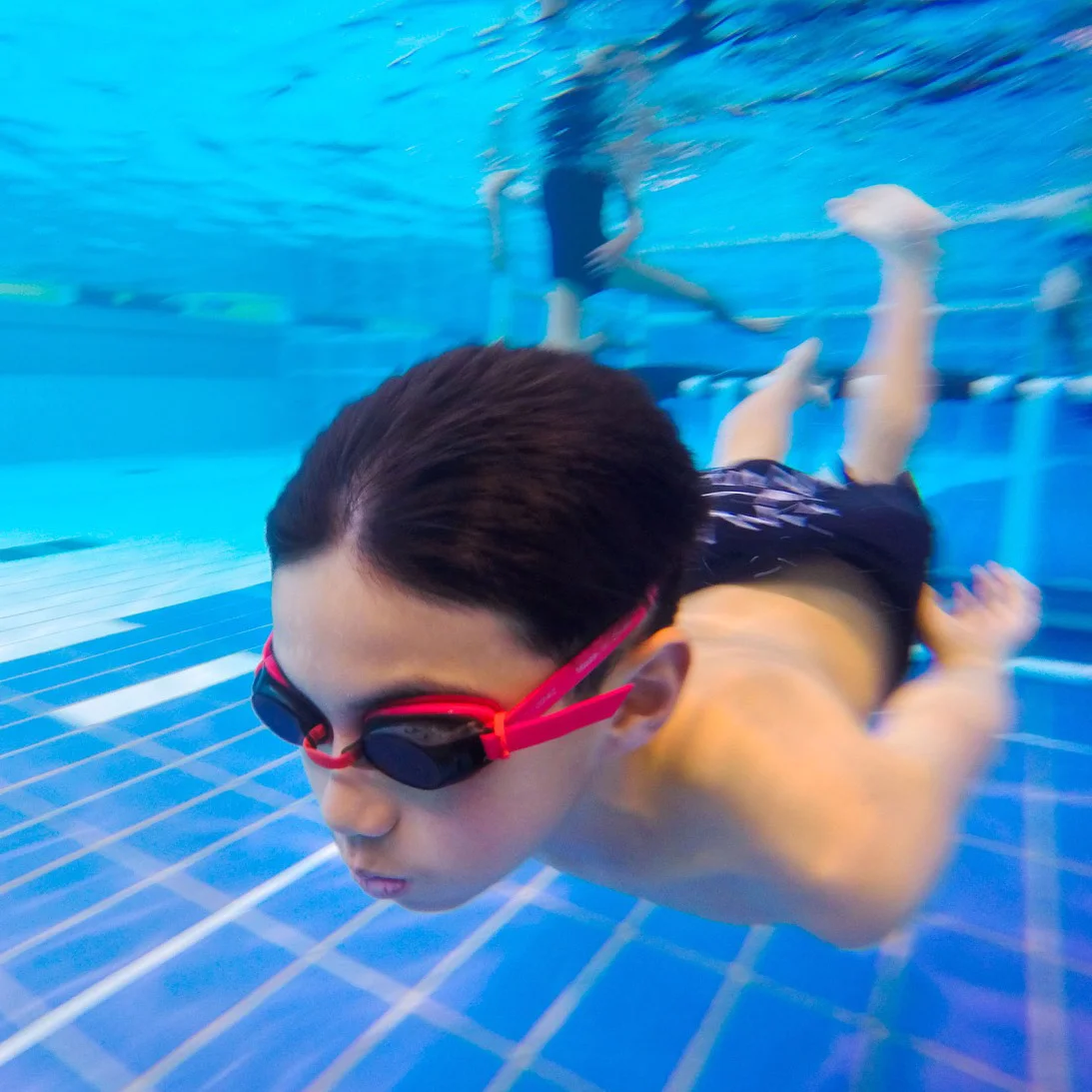 Boy swimming under water.