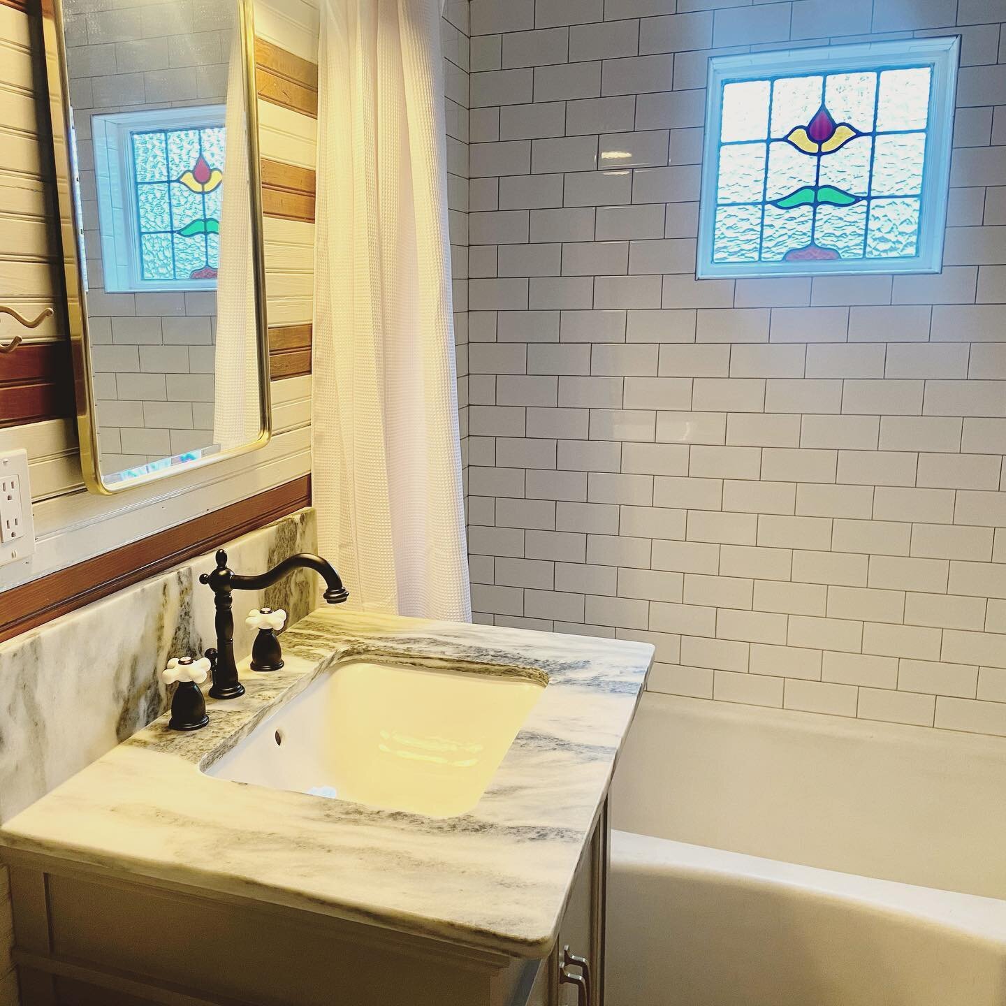 And we have a faucet! Some caulk and touch-up paint and this bathroom is done #atlonglast #victorianrenovation #victorianbathroom #bathroomfaucet #marble #stainedglass #subwaytile #brass #beadboard #naturalwood #vintagetub #reclaimedmaterials #oldhou