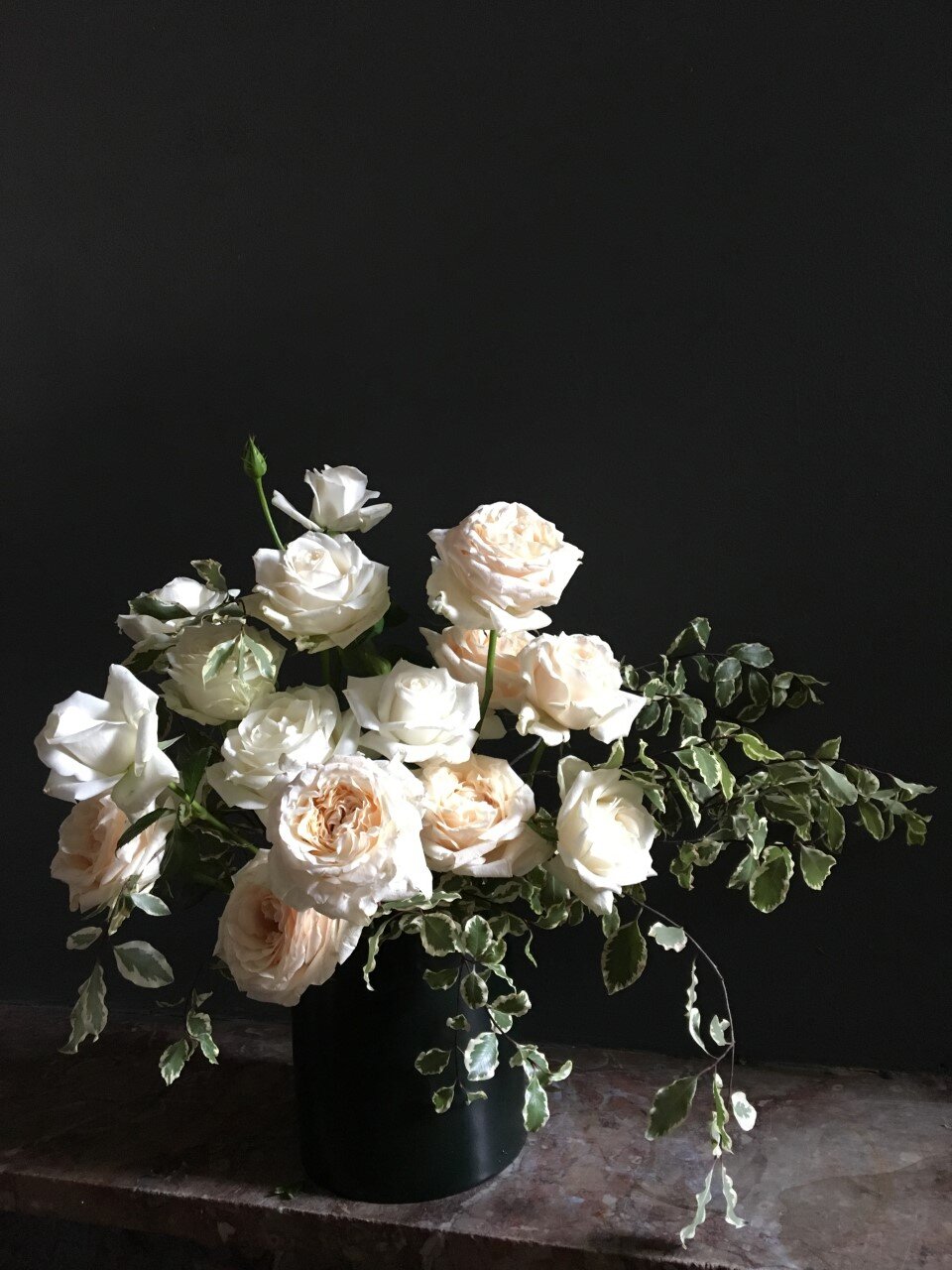 Garden roses in emerald green metal vessel.jpg