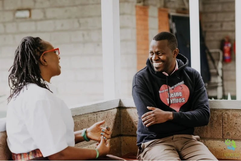 A Keheala supporter speaks to a patient about his treatment plan. Photographed by Creatis Agency.