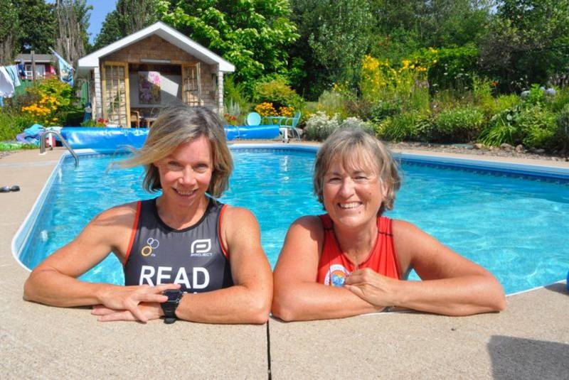 Coach Shannon Read, left, and Masters level athlete Anne Murray cool off in Murray’s New Minas pool one sunny day recently.