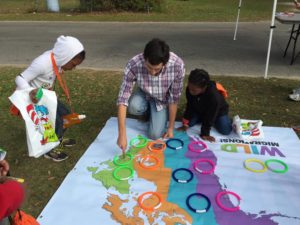 Peter Kleinhenz helps kids play the migration game. Photo by Elizabeth Platt