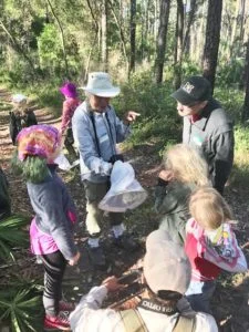 Bioblitz participants check out a butterfly captured by butterfly expert, Dean Jue, at the Aucilla WMA bioblitz. Photo by Andy Wraithmell