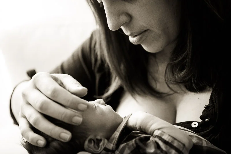 black and white photograph of mother connecting with her newborn