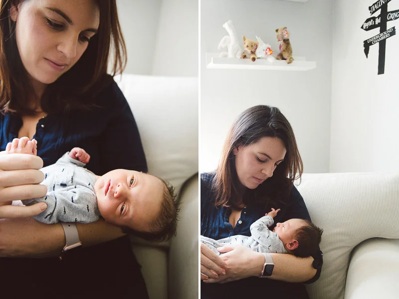 woman holds her tiny baby while he grasps toward her