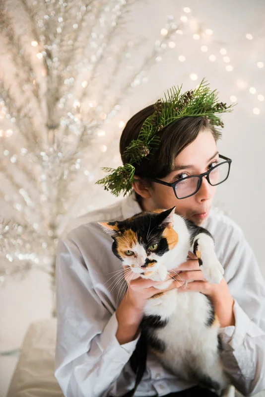 christmas theme teen boy holding a cat