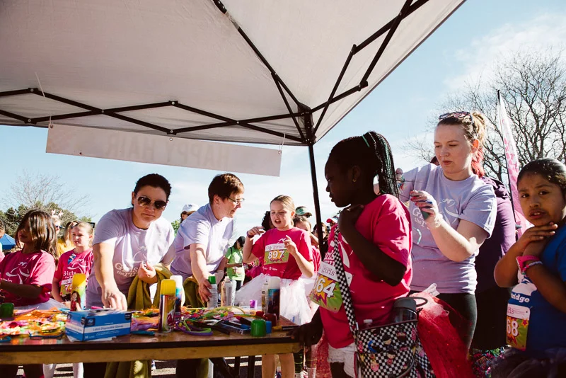 volunteers working in the happy hair booth
