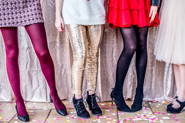 Legs of teen girls in fancy clothes.