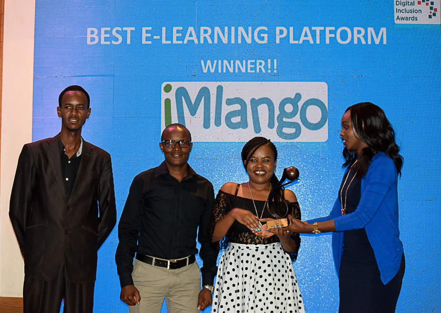 Anthony Kogi, Ernest Dishon and Wambui Maina from sQuid Kenya collect the award on behalf of the programme.