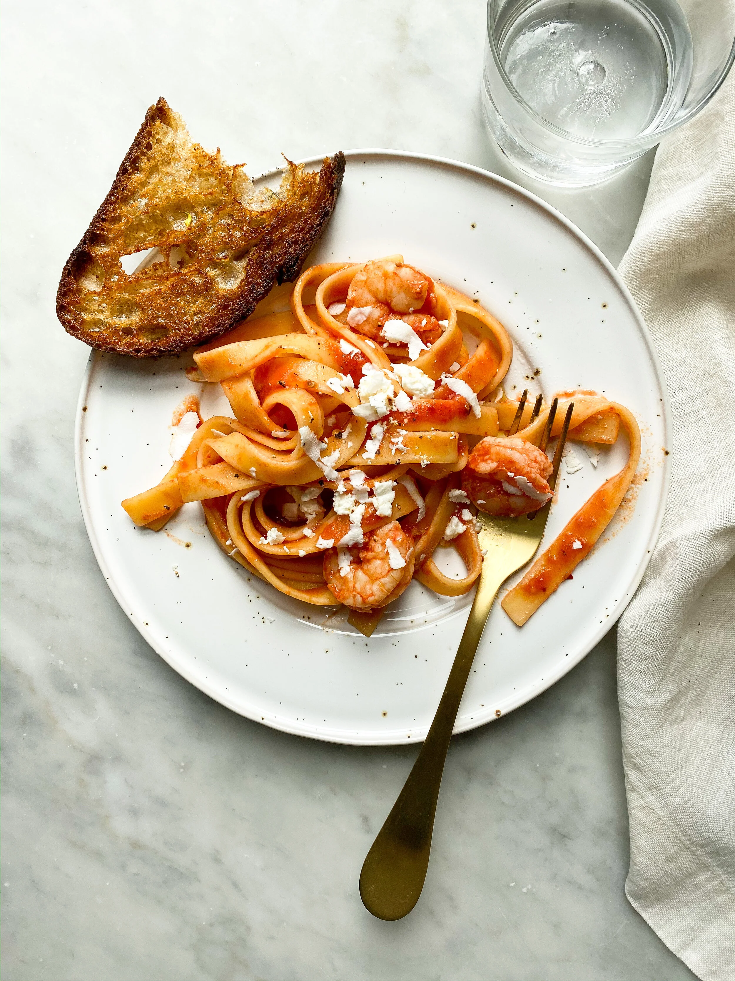 TAGLIATELLE WITH SPICY TOMATOES, SHRIMP AND AGED FETA  