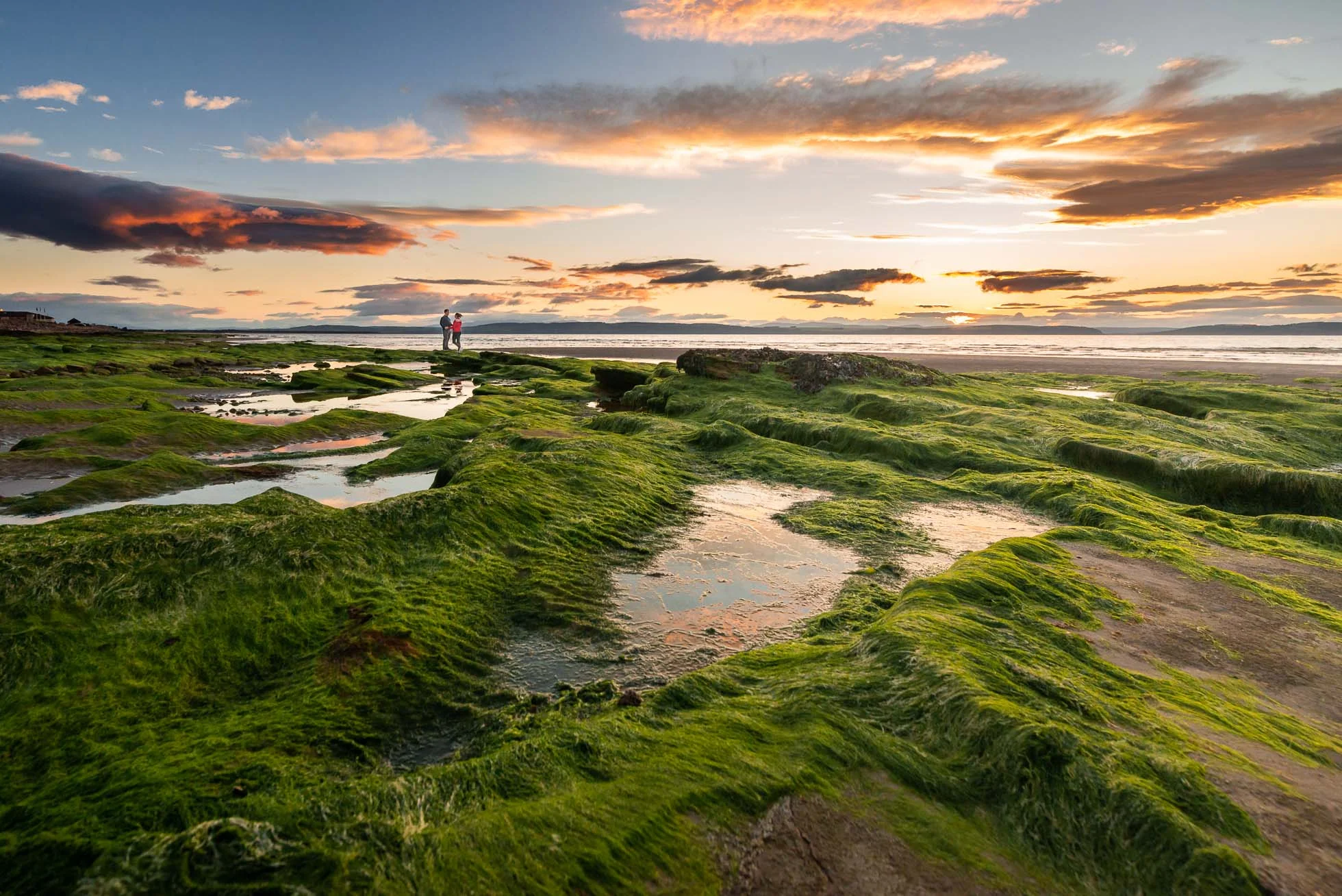 landscape-of-beach-in-scotland-at-sunset-with-couple-and-reflection-1.jpg