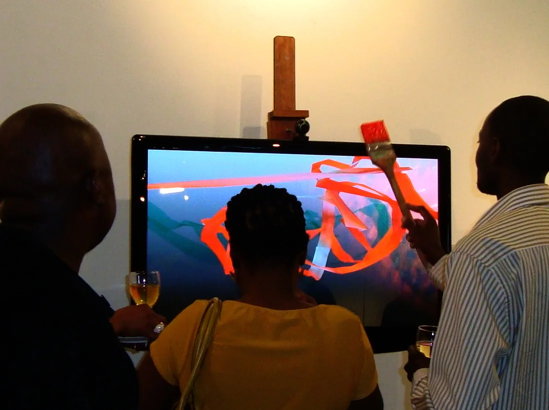    Wet Paint   2010 Artist’s Easel with LCD display,  speakers, web cam, computer system, software, paint brush. Installation view.  Sasol New Signatures  exhibition, Pretoria Art Museum. 