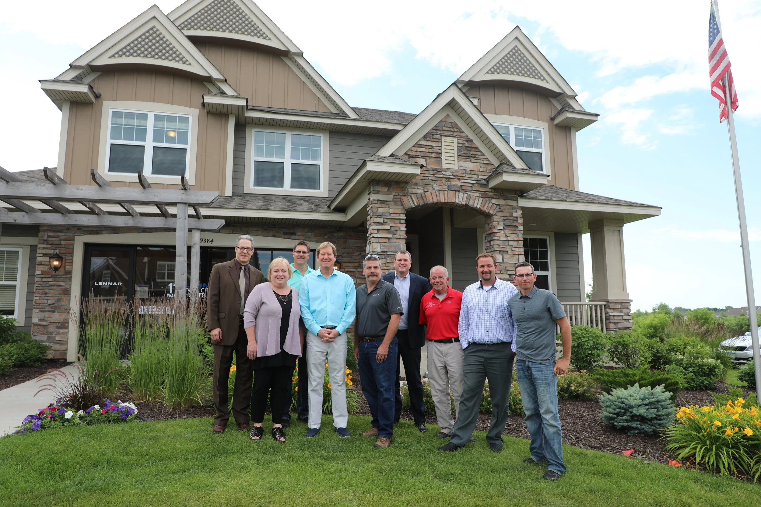 Housing First Minnesota members pose for a picture with Congressman Jason Lewis (CD2-R) outside a Lennar Minnesota model home in Lakeville, MN.
