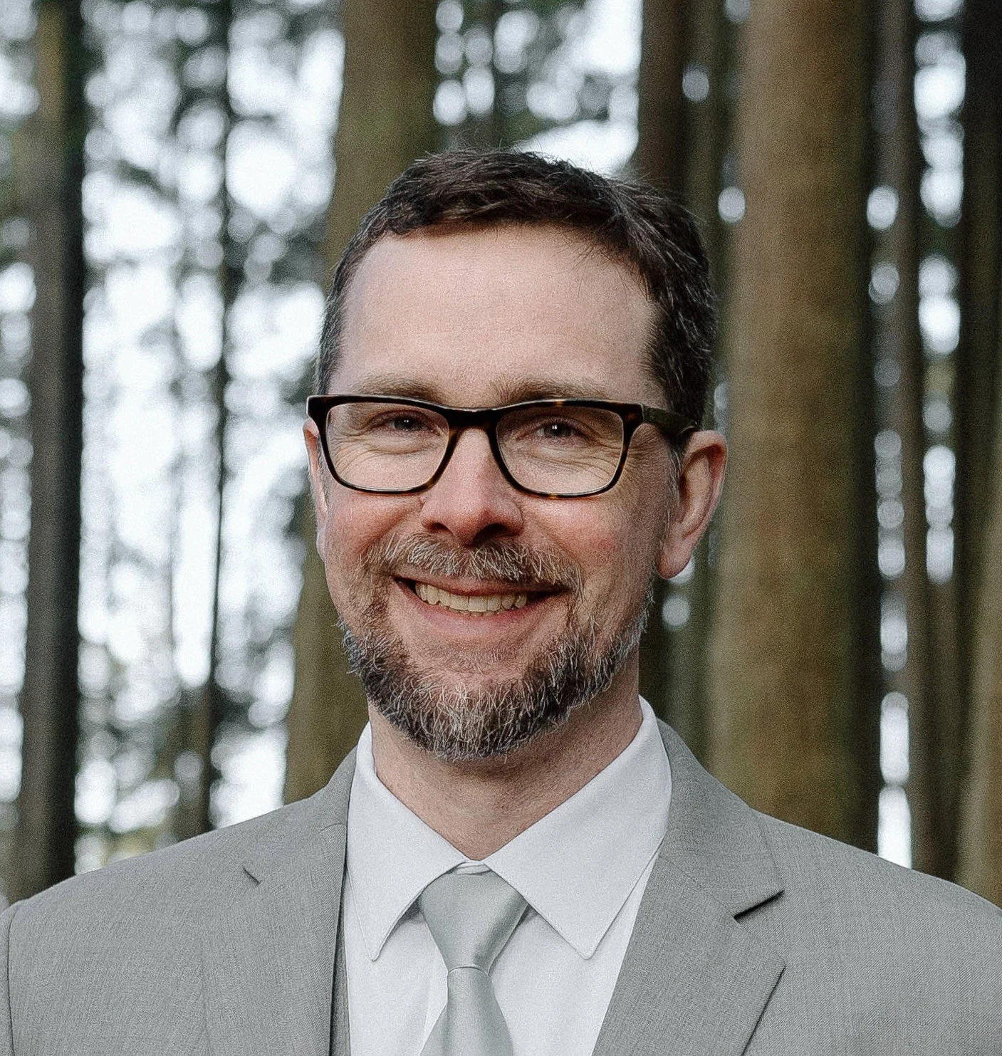 Picture of Matt Holland wearing a suit with trees as the background