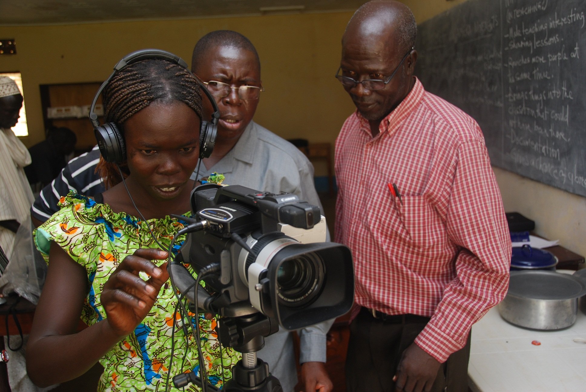 African teacher learning camera operation.JPG
