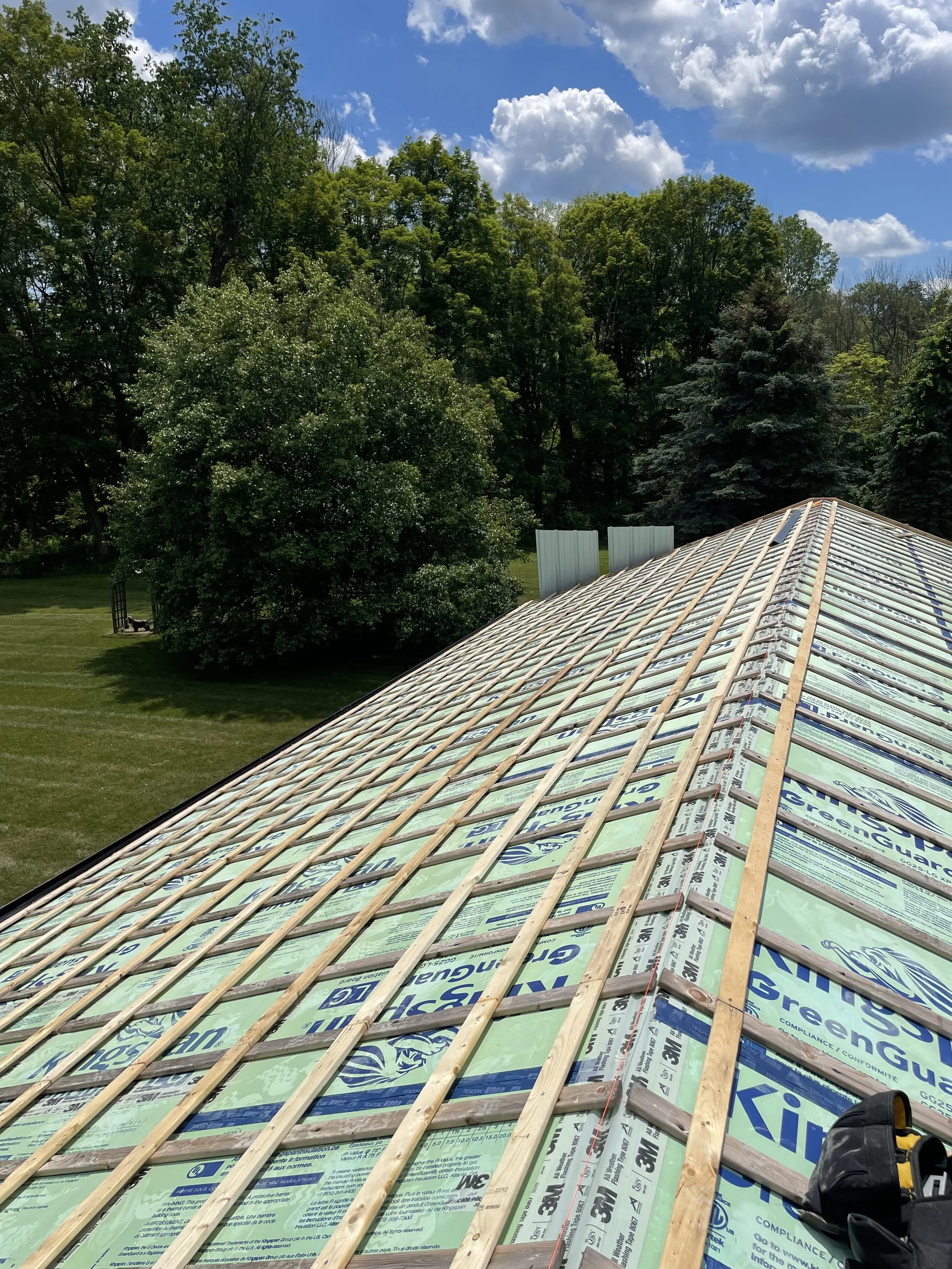 Roof with exterior insulation and rain screen battens installed