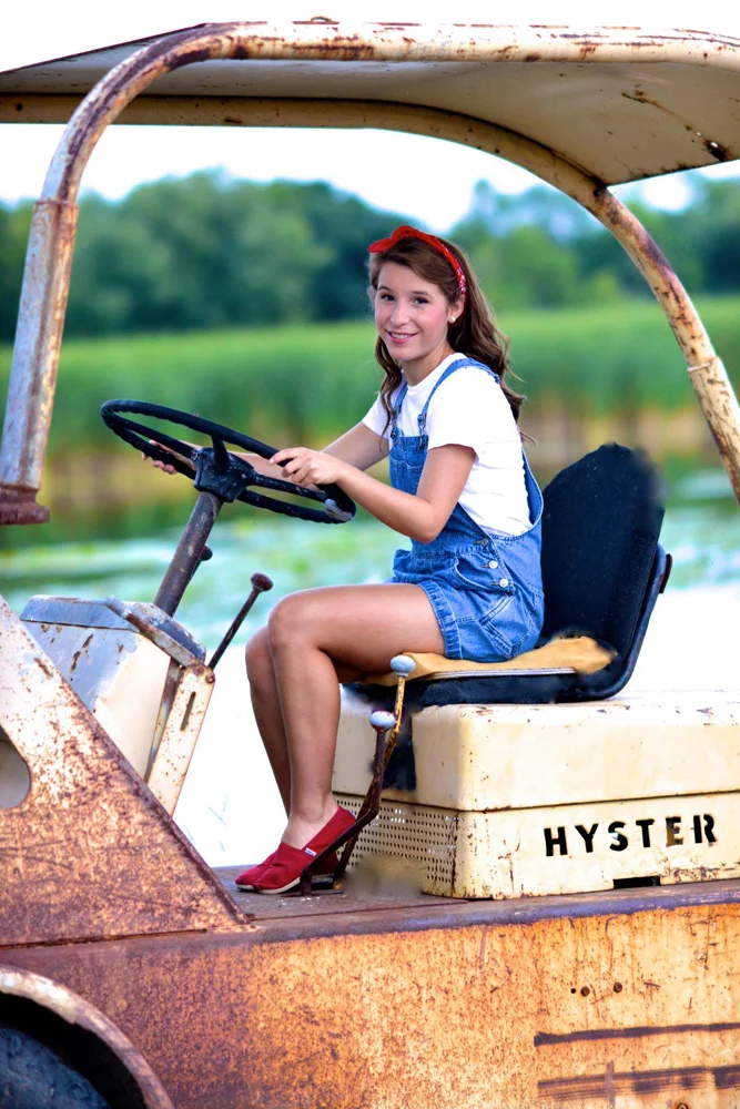 Lifestyle photography girl riding tractor
