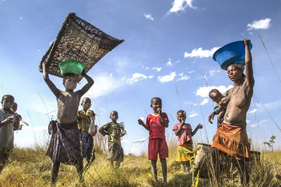 Above: The Nganguela people of the Cuito River region. Photo: James Kydd Below: Young Luchaze hunters use motorcycles to take bushmeat hunted and smoked in the wilderness to towns. Photo: Ben van der Waal