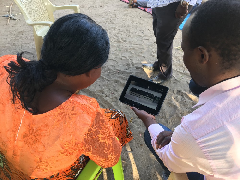 Charles Kayuki shows Asha Mohammad Nanopore sequencing technology. Photo: Laura Boykin