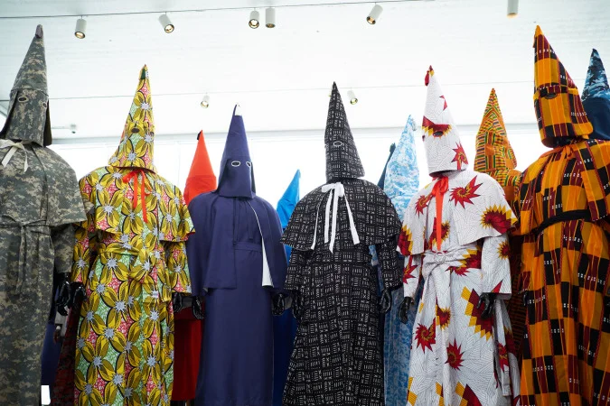 “The robes’ attractiveness and playfulness and the cultural associations of their fabrics and patterns highlight the power of the hood’s shape, a power that it still holds today,” says Rucker. “The pink butterfly floral print is an Asian pattern, because the KKK was not only against black people; it was also against Asian people — actually, anyone besides Protestant whites. That robe also references the history of the Chinese Exclusion Act of 1882 and the Japanese incarceration during World War II.”