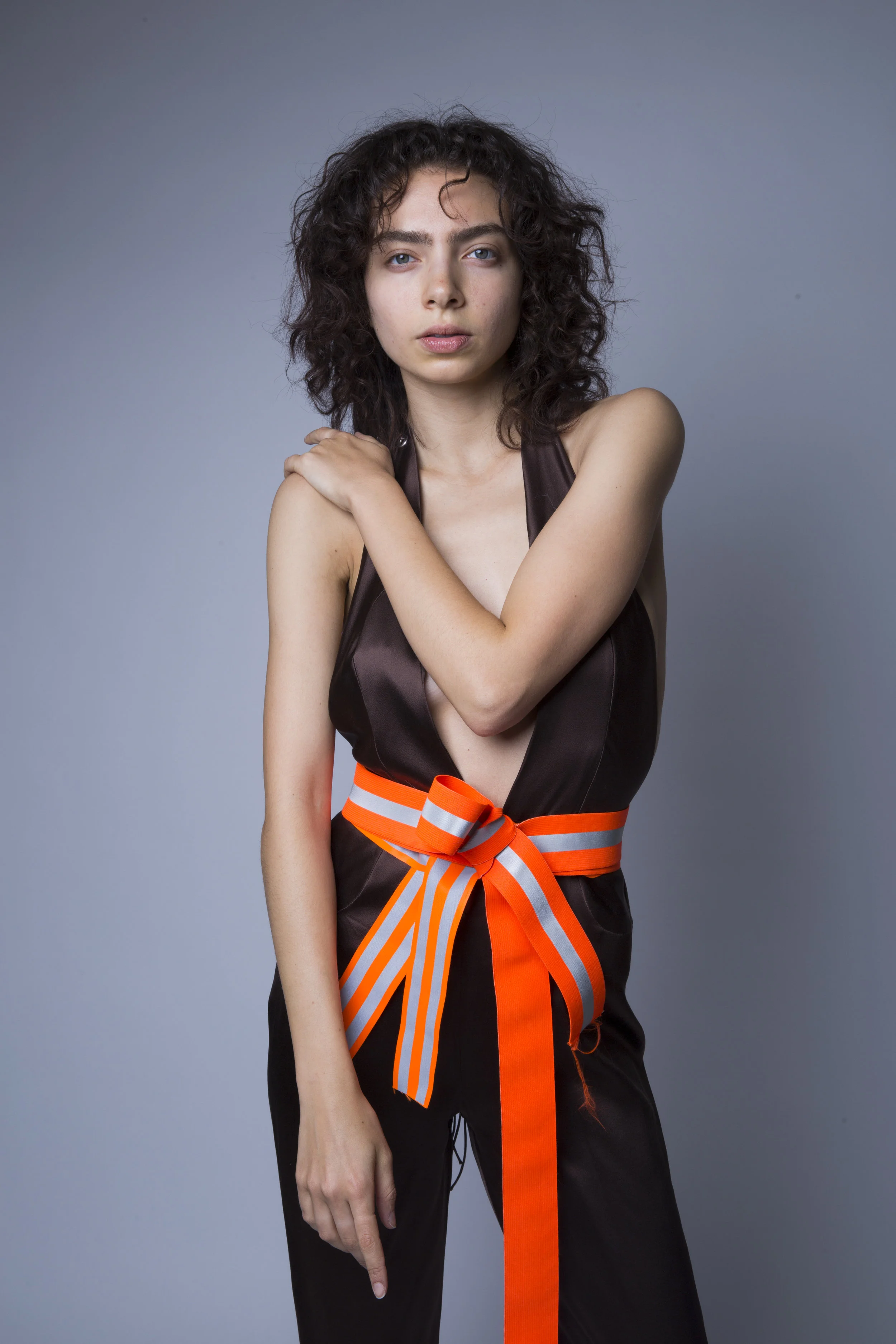  Allison is wearing a Silk Crepe Backed Satin, backless jumpsuit with a raw reflective tape belt. Made to Order. inquire directly for price. 