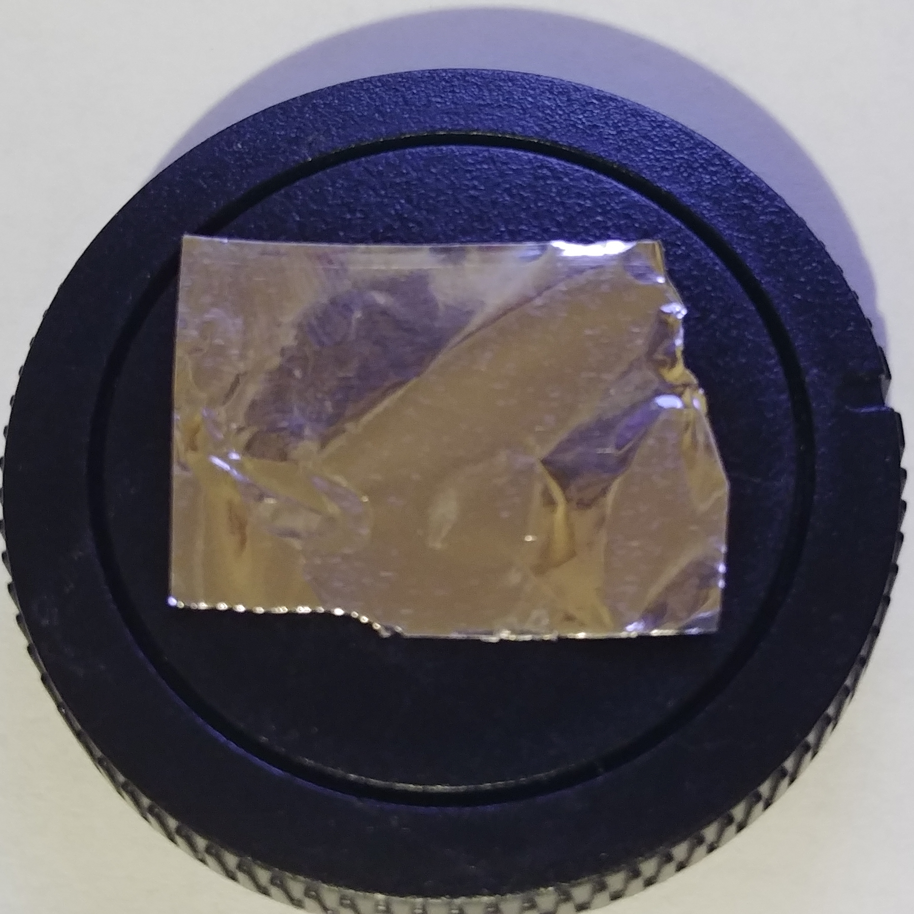 Cut a piece of foil big enough to cover the hole and then some.